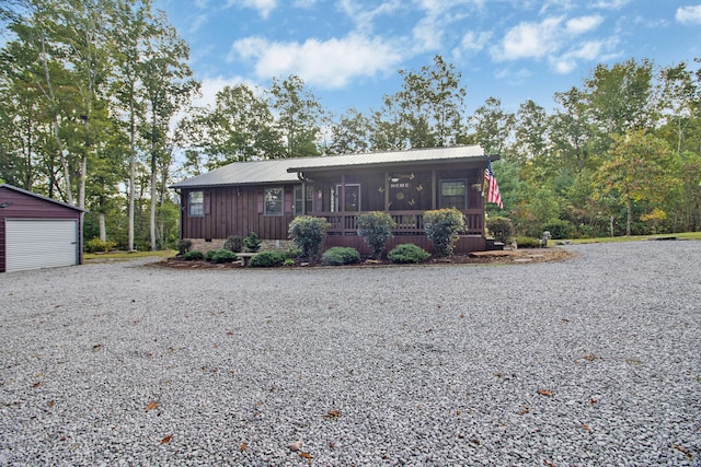 ranch-style home with a garage and an outdoor structure