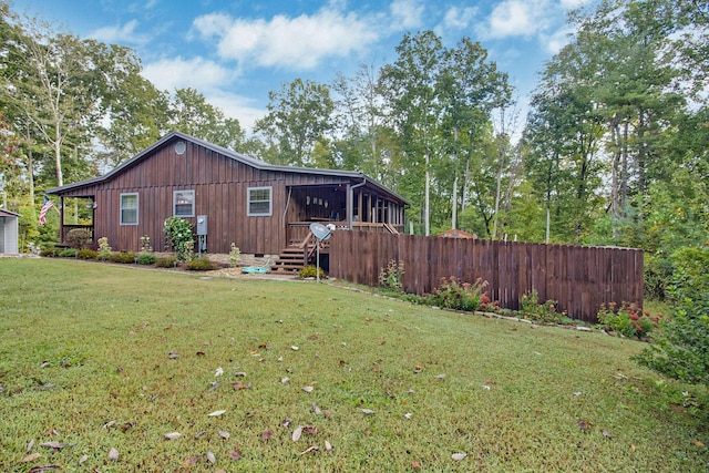 back of house featuring a lawn