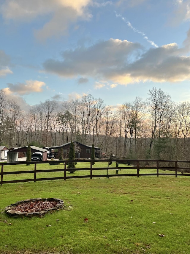 view of community with a lawn and a rural view