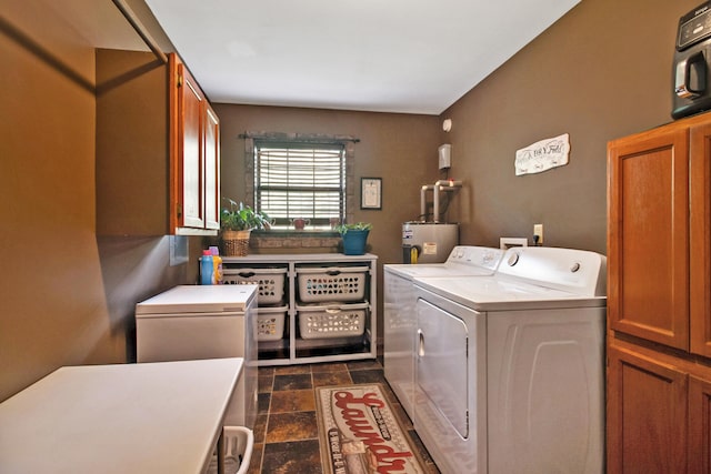 laundry area with washer and dryer, water heater, and cabinets