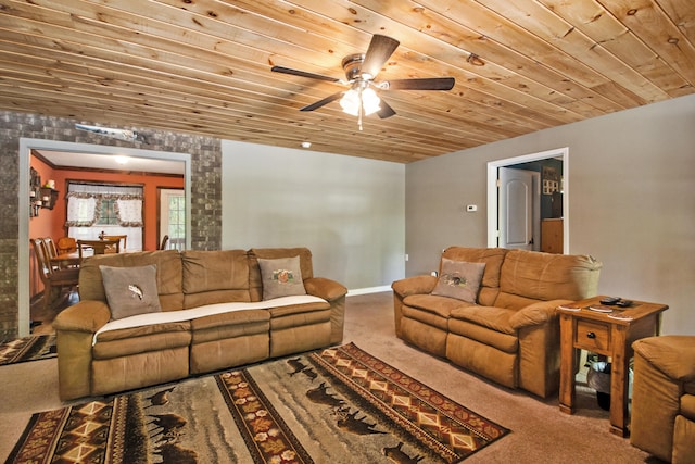 living room featuring ceiling fan, carpet, and wooden ceiling