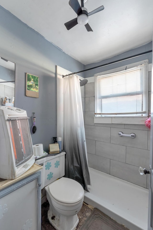 bathroom featuring ceiling fan, toilet, and a shower with shower curtain