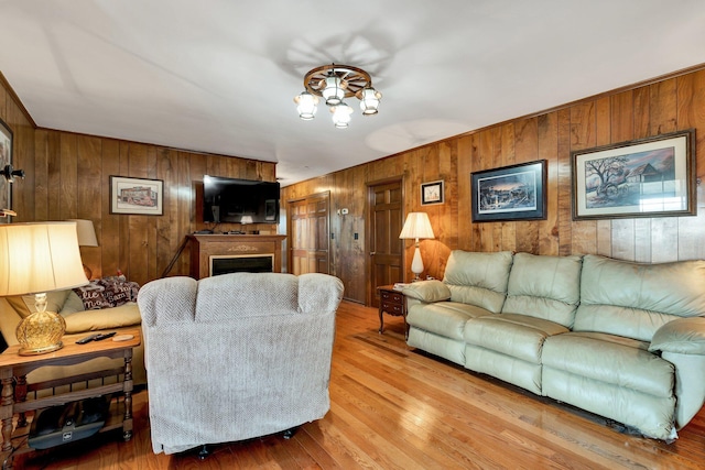 living room featuring wooden walls and light wood-type flooring