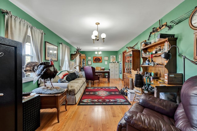 living room with a notable chandelier and light wood-type flooring