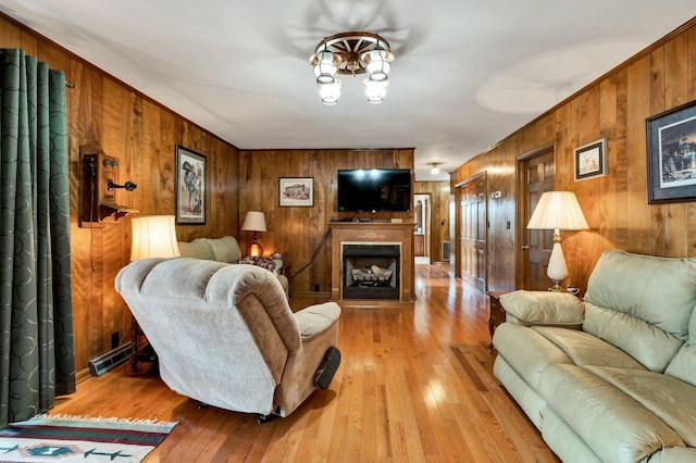 living room featuring light hardwood / wood-style flooring and wood walls