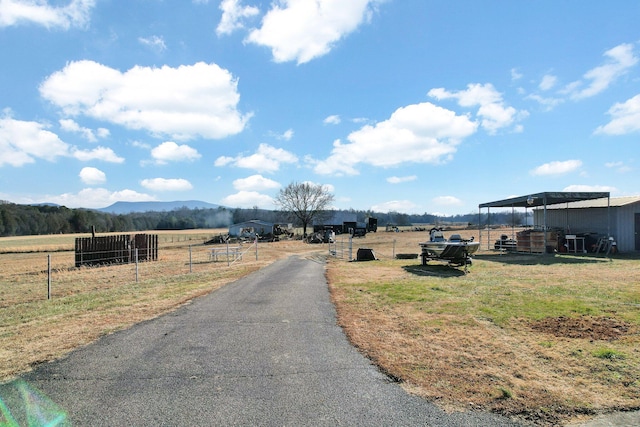 view of street with a mountain view and a rural view