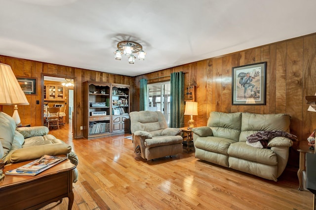 living room with hardwood / wood-style flooring and wooden walls