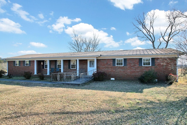 ranch-style house with a front yard and covered porch