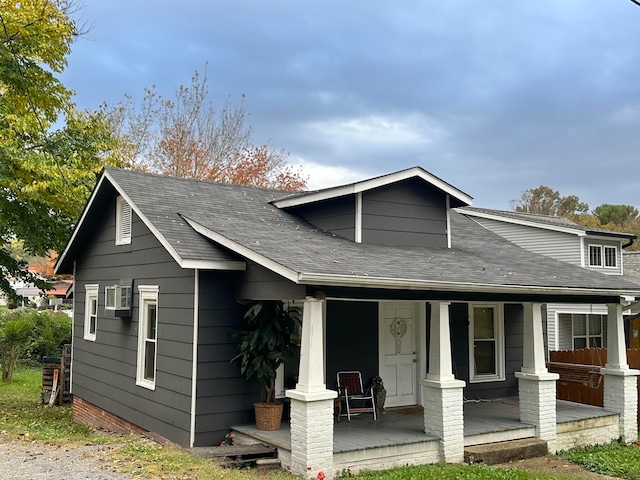 view of front of house with a porch and roof with shingles