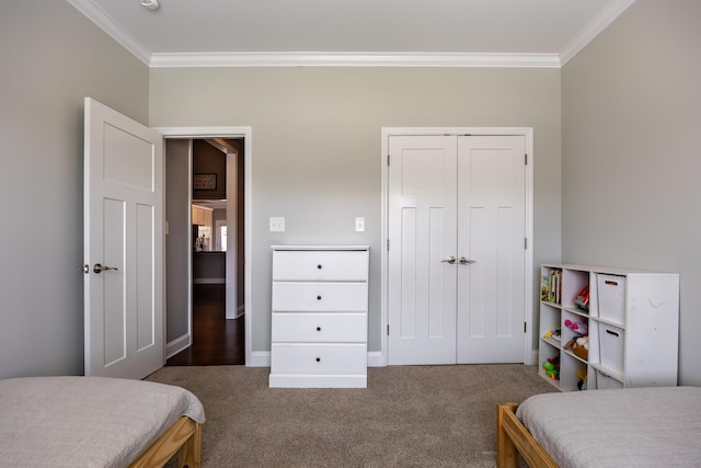 bedroom with a closet, carpet flooring, and crown molding