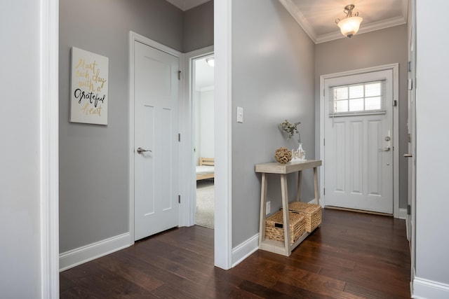 foyer featuring ornamental molding, dark wood finished floors, and baseboards