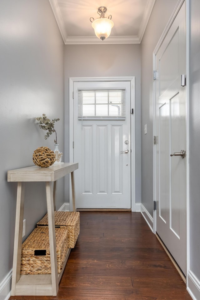 doorway with baseboards, ornamental molding, and wood finished floors