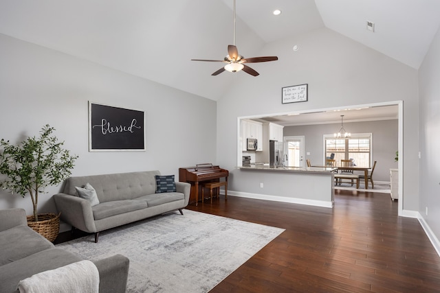 living room featuring baseboards, dark wood-type flooring, ceiling fan with notable chandelier, high vaulted ceiling, and recessed lighting