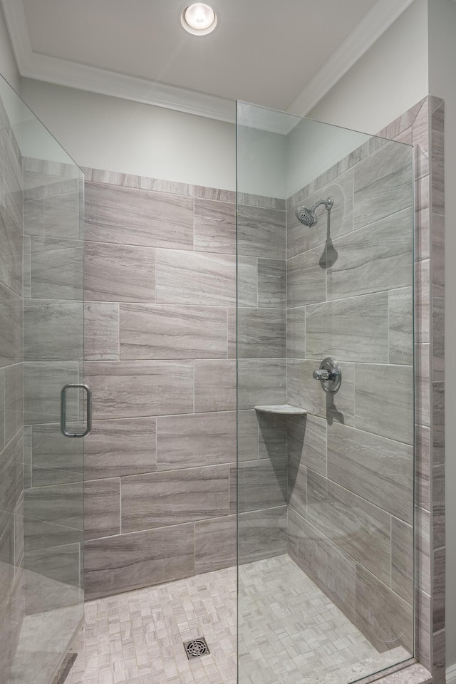 full bath featuring a stall shower and crown molding