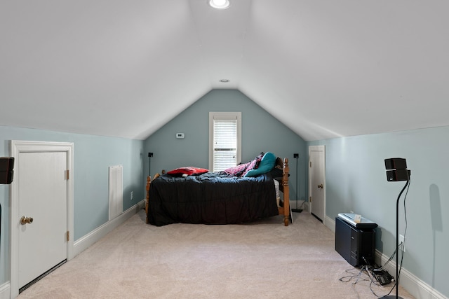 carpeted bedroom featuring visible vents, baseboards, and vaulted ceiling