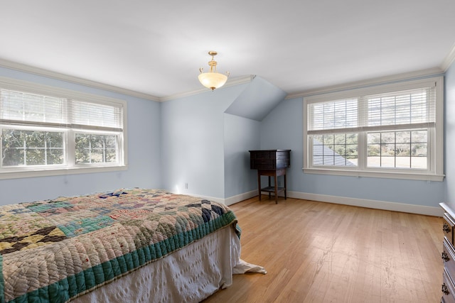 bedroom featuring baseboards, multiple windows, light wood-style floors, and crown molding