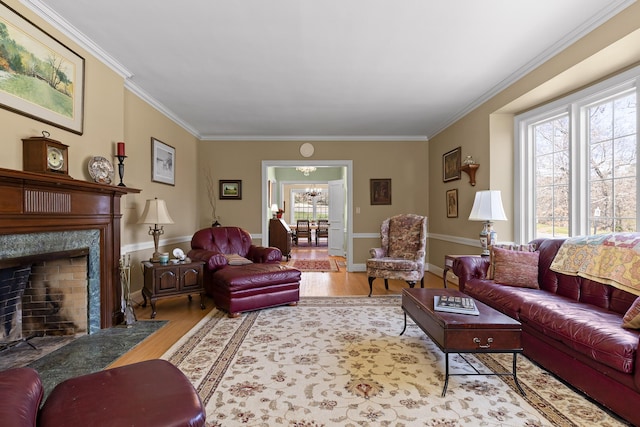 living area featuring crown molding, wood finished floors, a chandelier, and a premium fireplace