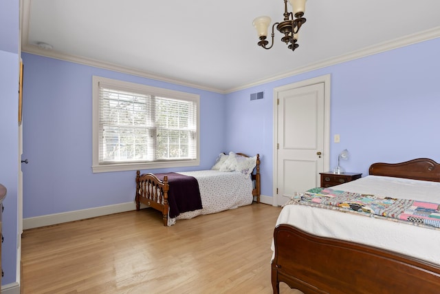 bedroom featuring ornamental molding, light wood-style floors, visible vents, and a chandelier