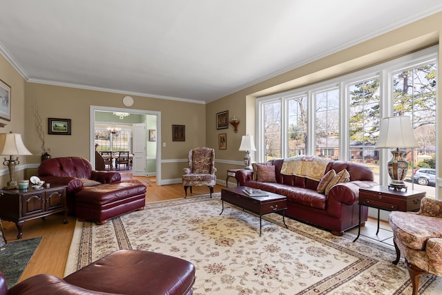 living area with light wood-type flooring, a chandelier, and crown molding