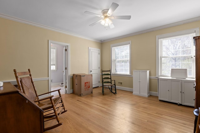 living area featuring a ceiling fan, baseboards, visible vents, light wood-style flooring, and crown molding