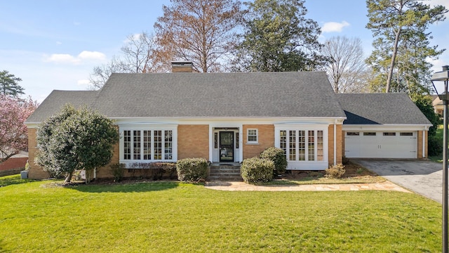 cape cod-style house featuring a front yard, a chimney, a shingled roof, concrete driveway, and a garage