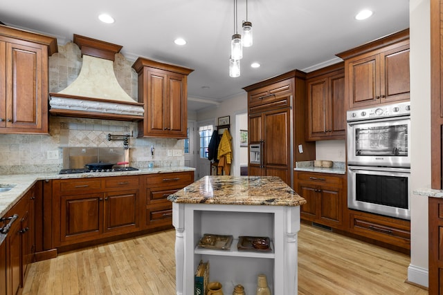 kitchen featuring ornamental molding, custom range hood, open shelves, light stone counters, and stainless steel appliances