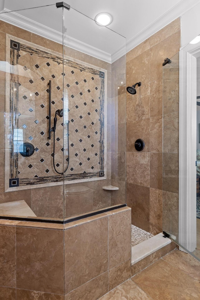 full bath with a shower stall and crown molding