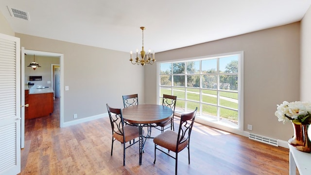 dining room featuring hardwood / wood-style floors and a notable chandelier