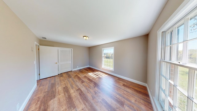 unfurnished bedroom with a closet and wood-type flooring