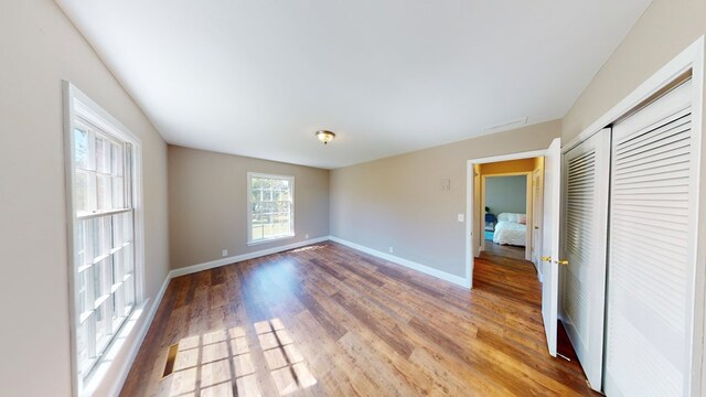 unfurnished room with wood-type flooring