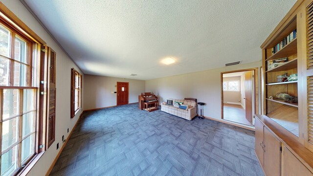 unfurnished room with a textured ceiling