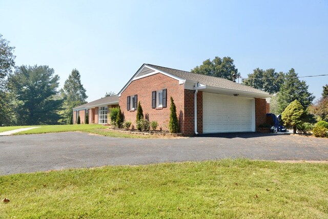 single story home with a front yard and a garage