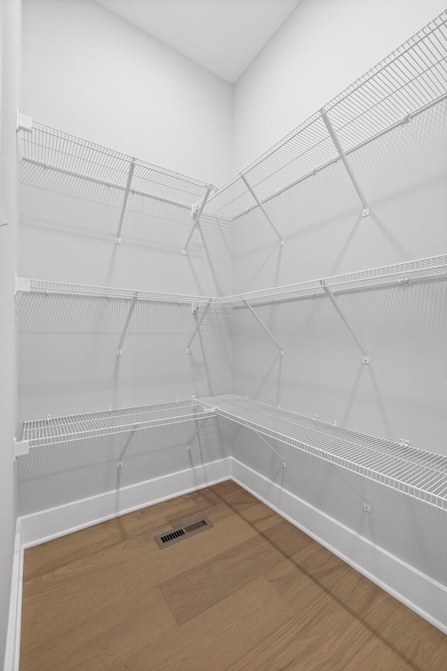 spacious closet with visible vents and wood finished floors