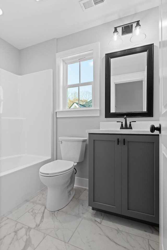 bathroom featuring toilet, marble finish floor, and visible vents