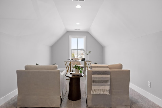 living area featuring carpet, visible vents, vaulted ceiling, and baseboards