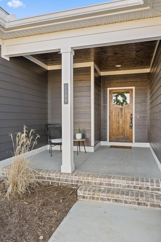 doorway to property featuring covered porch