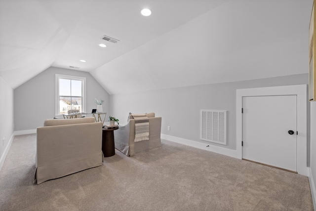 office featuring lofted ceiling, light carpet, visible vents, and baseboards