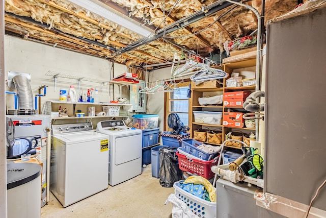 laundry area featuring gas water heater and washing machine and clothes dryer