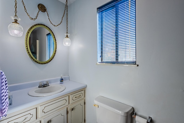 bathroom featuring vanity, toilet, and plenty of natural light