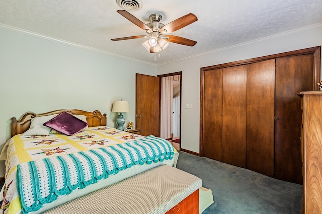 carpeted bedroom with ceiling fan, ornamental molding, a textured ceiling, and a closet