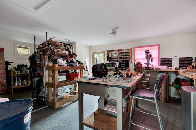 home office with a workshop area and concrete flooring