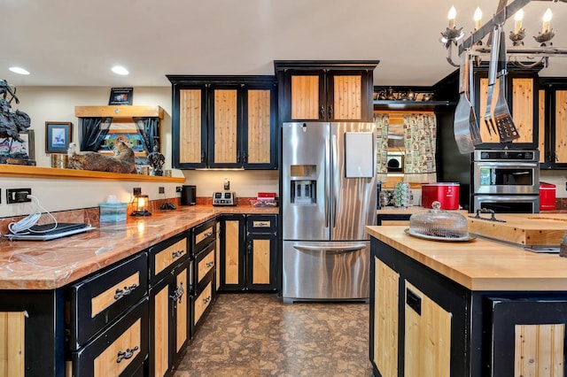 kitchen featuring wooden counters and appliances with stainless steel finishes