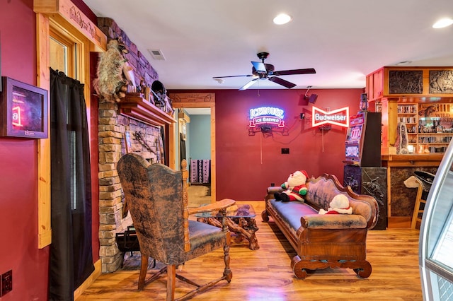 sitting room featuring ceiling fan and wood-type flooring