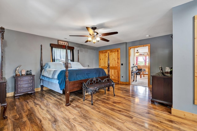 bedroom with ceiling fan and wood-type flooring