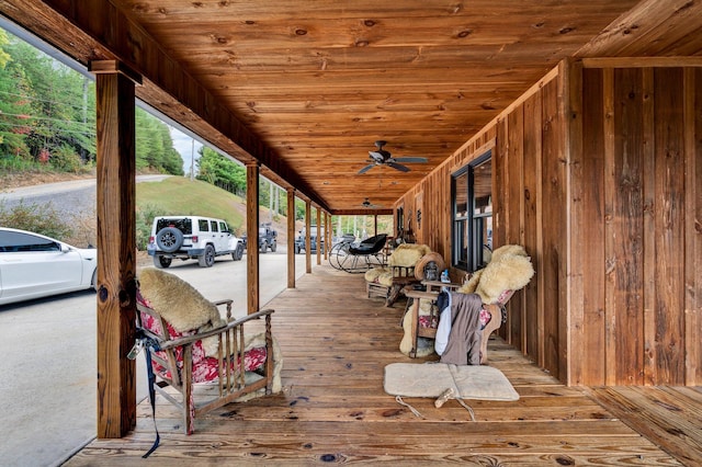 wooden terrace featuring ceiling fan and covered porch