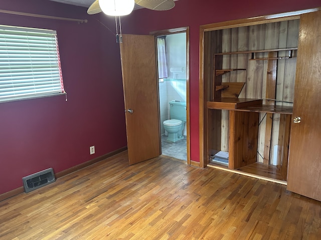 119 Cane Creek Rd, Rocky Top, TN 37769 - unfurnished bedroom featuring wood finished floors, ensuite bathroom, and baseboards