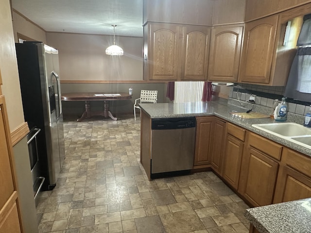119 Cane Creek Rd, Rocky Top, TN 37769 - kitchen featuring appliances with stainless steel finishes, a sink, a peninsula, brown cabinets, and light countertops