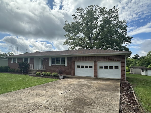119 Cane Creek Rd, Rocky Top, TN 37769 - ranch-style home featuring driveway, a garage, a shed, brick siding, and a front yard