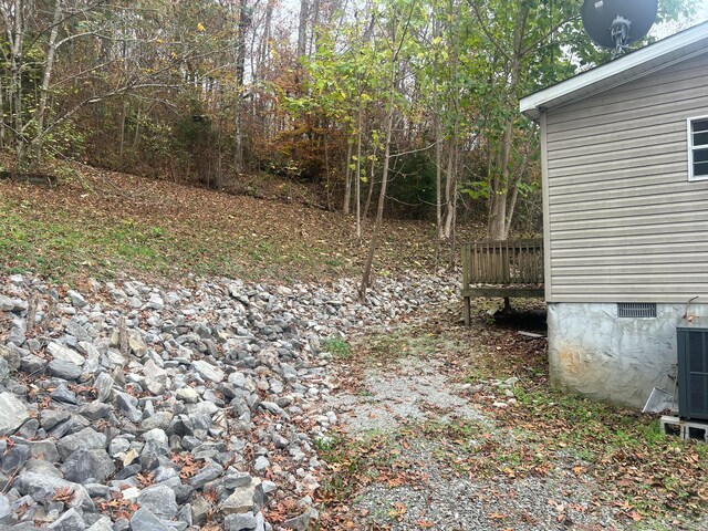 view of yard with a wooden deck and central AC