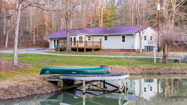 dock area with a deck with water view, central AC, and a lawn